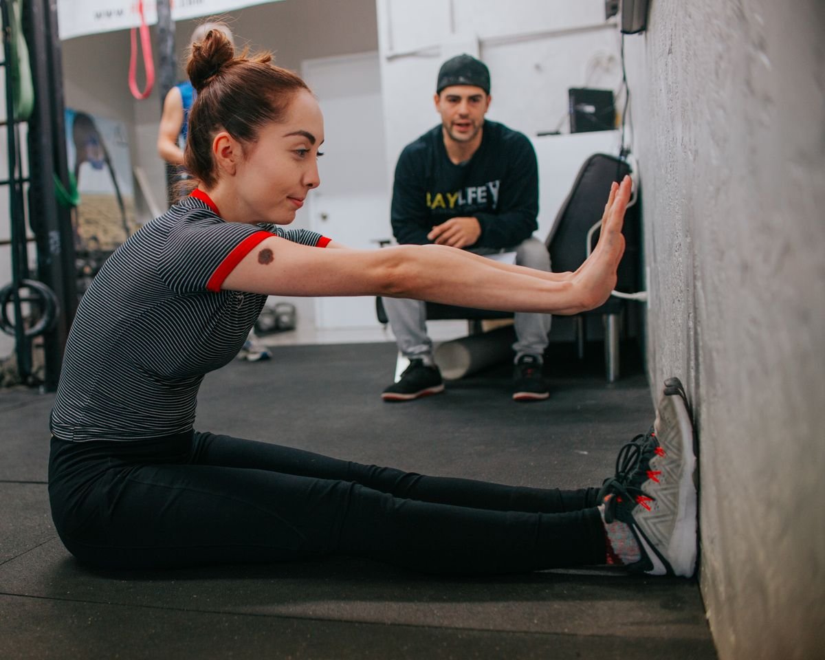 Trainer coaching a member through a personal training session